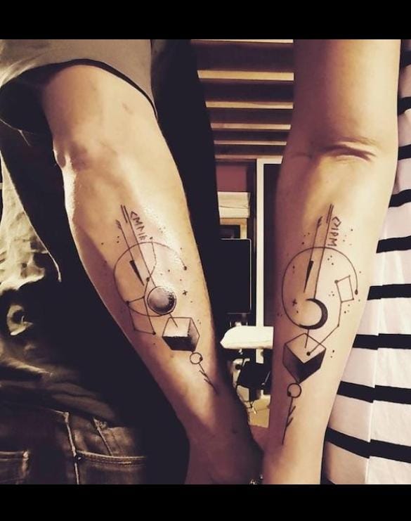 Couple showing matching tattoo designs on their arms