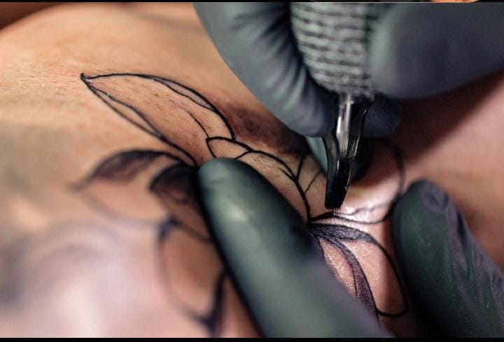 Hand showing a temporary tattoo design for comparison with permanent ink