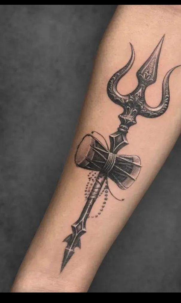 Tattoo artist creating a Hindu spiritual symbol tattoo with lotus design